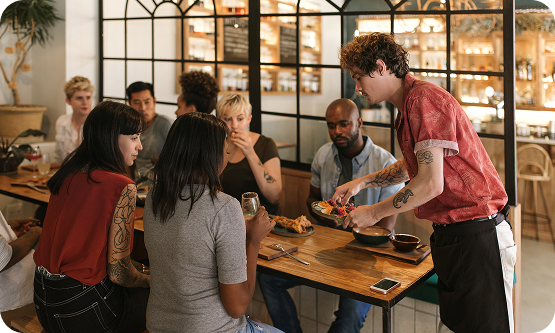 Server bringing food to guests in a restaurant